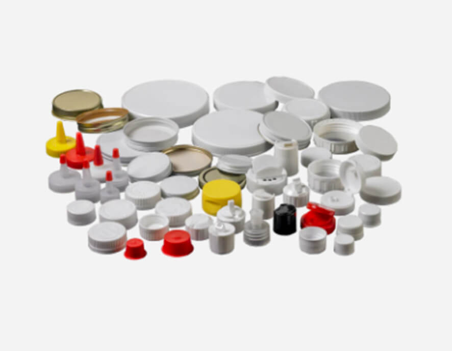 A collection of assorted plastic and metal bottle caps and lids in various sizes and colors, including white, red, yellow, and silver, arranged on a white background.