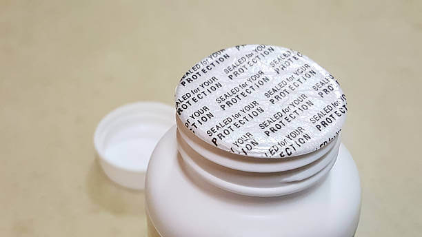 A close-up of a white plastic bottle with a security seal reading 